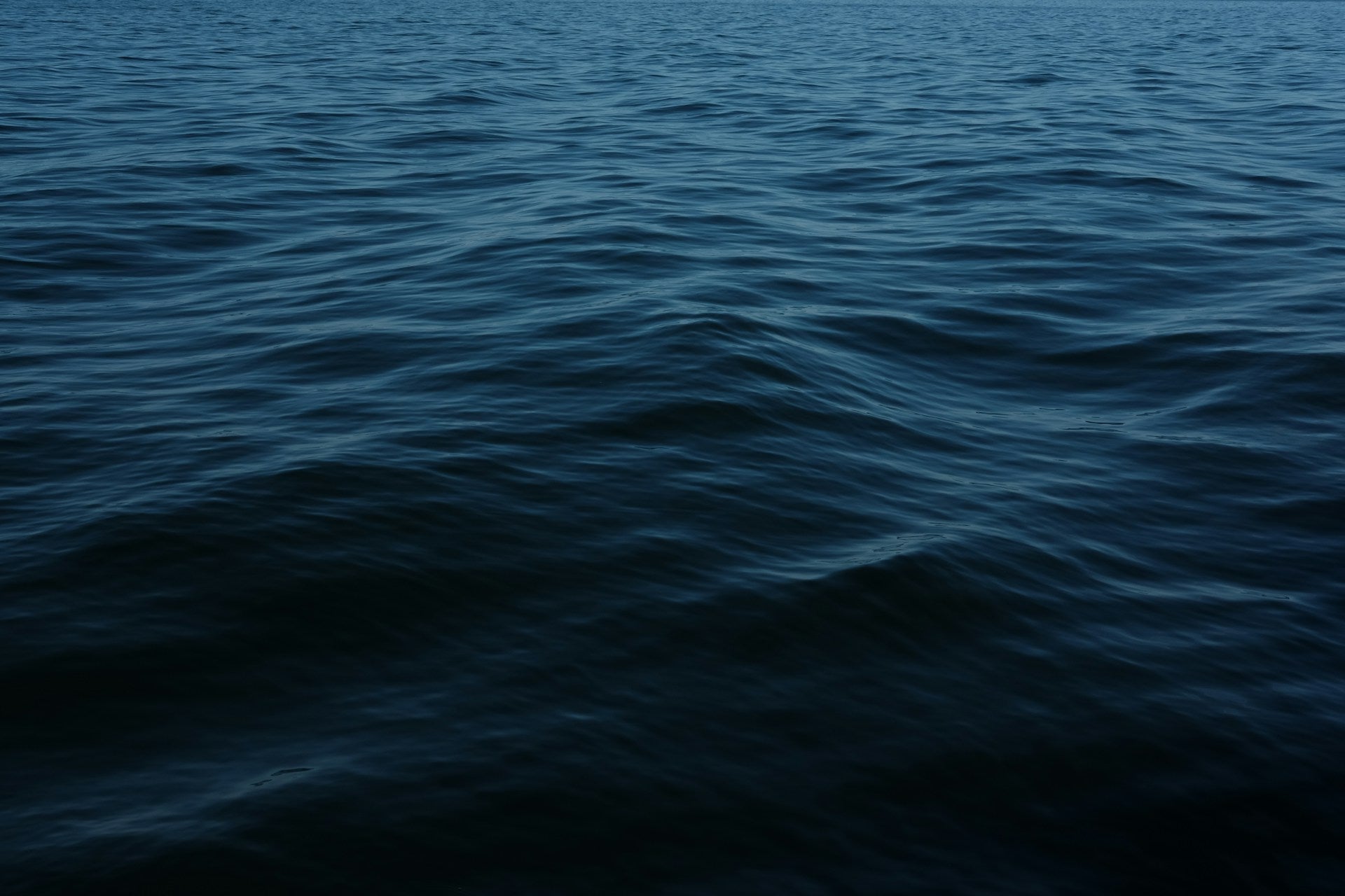 Dark blue ocean surface with gentle waves