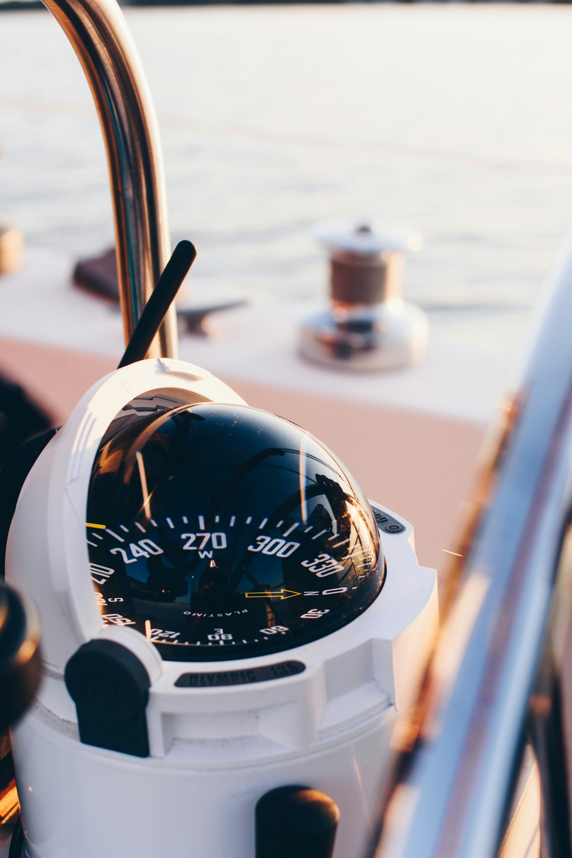 Close-up of a compass on a boat with blurred background